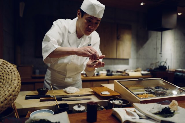 A chef performs art of cooking.