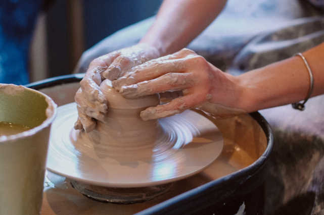 A potter throwing clay.